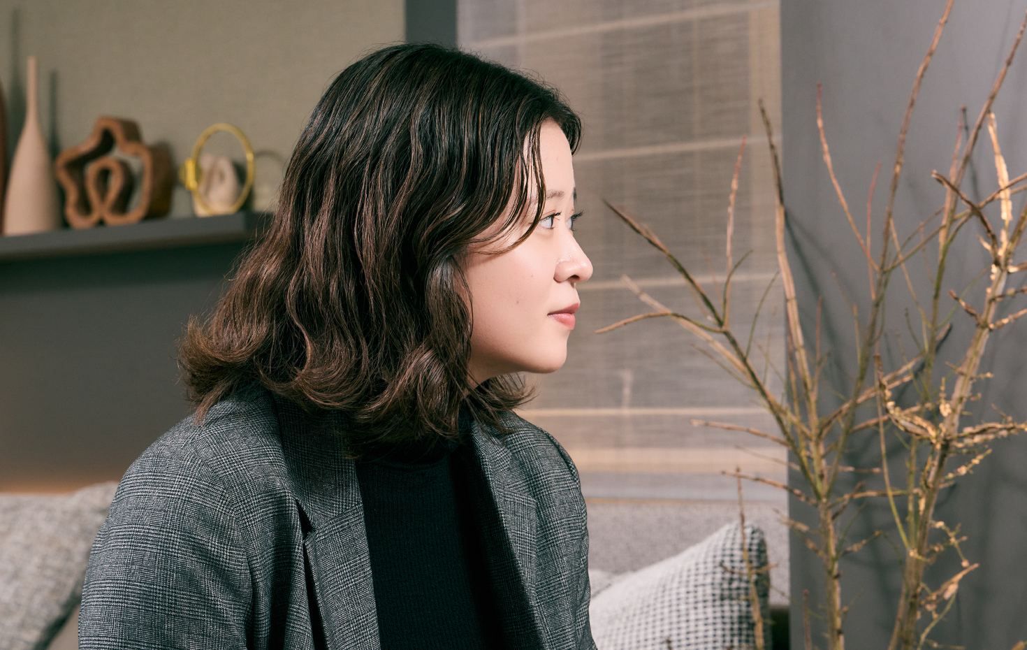 低層マンションと、ルネグラン上石神井の魅力を語る担当者の写真